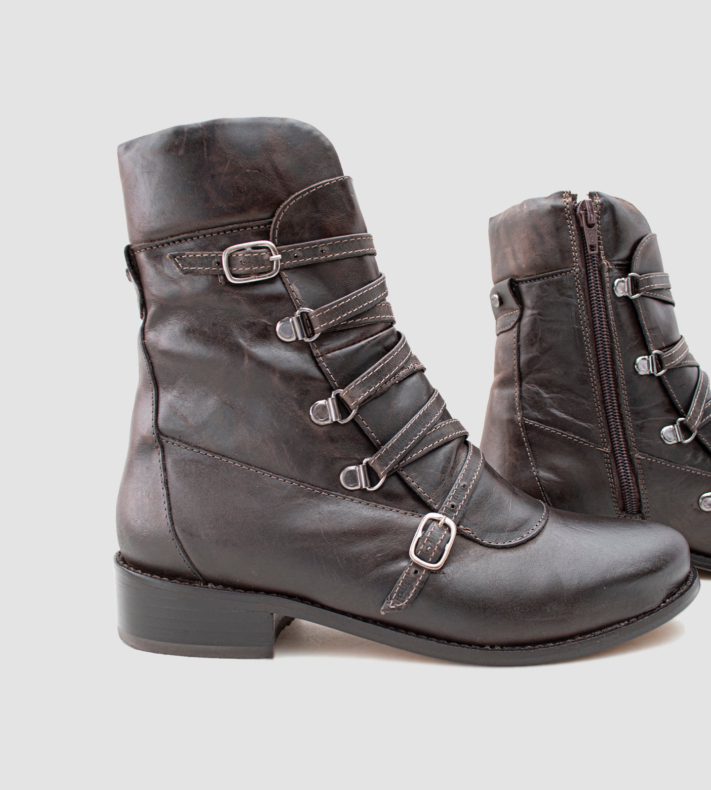 Bota feminina em couro legítimo preto com acabamento envelhecido, inspirada no estilo marcante das botas da Luiza Barcellos. O modelo de cano médio traz detalhes em fivelas e costuras aparentes, além de salto grosso baixo de 3 cm que garante conforto e elegância para o dia a dia. Ideal para compor looks modernos com personalidade e sofisticação.