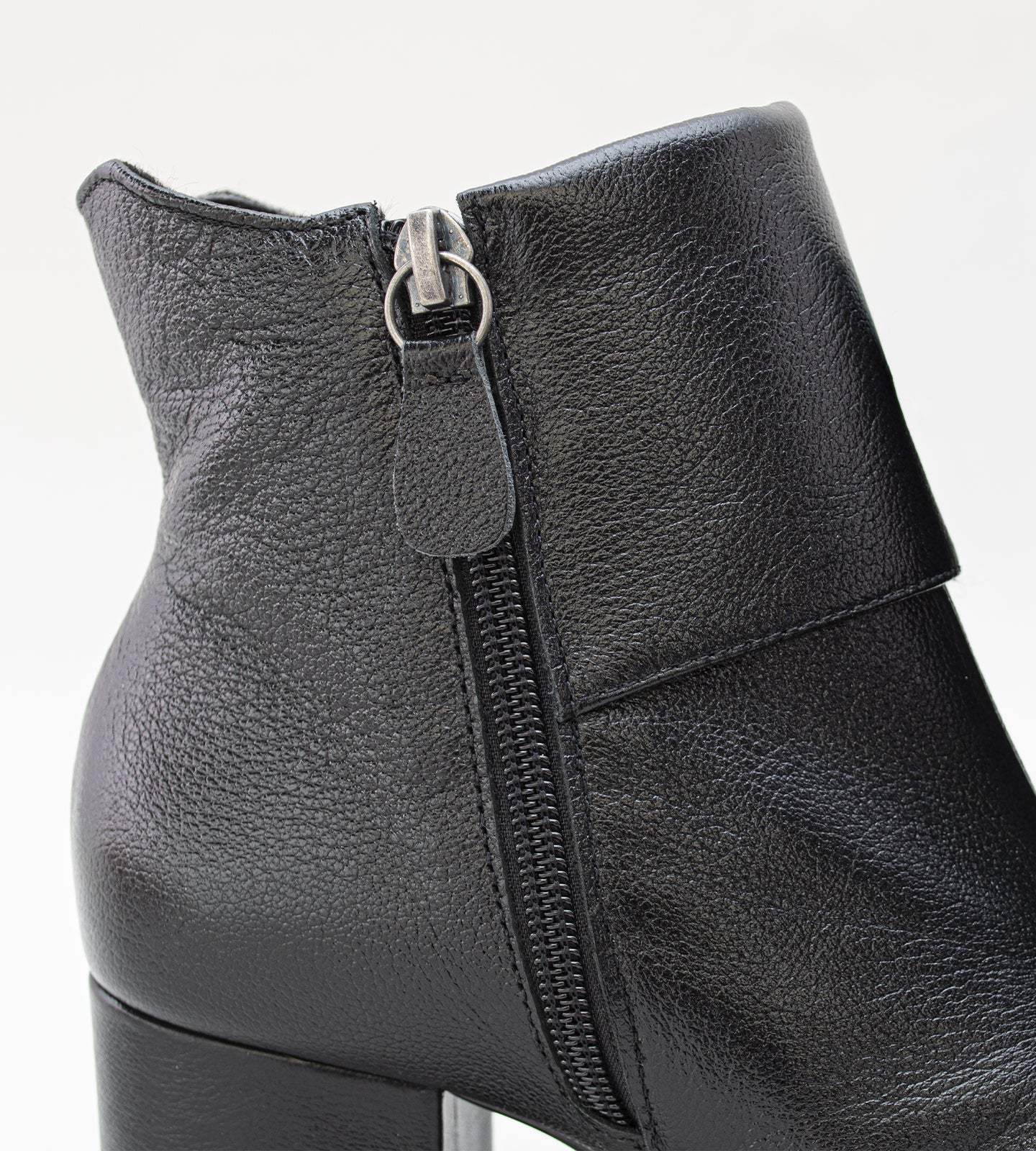 Bota feminina cano médio em couro preto com bico quadrado, salto bloco médio e fechamento em zíper lateral, design moderno e elegante.