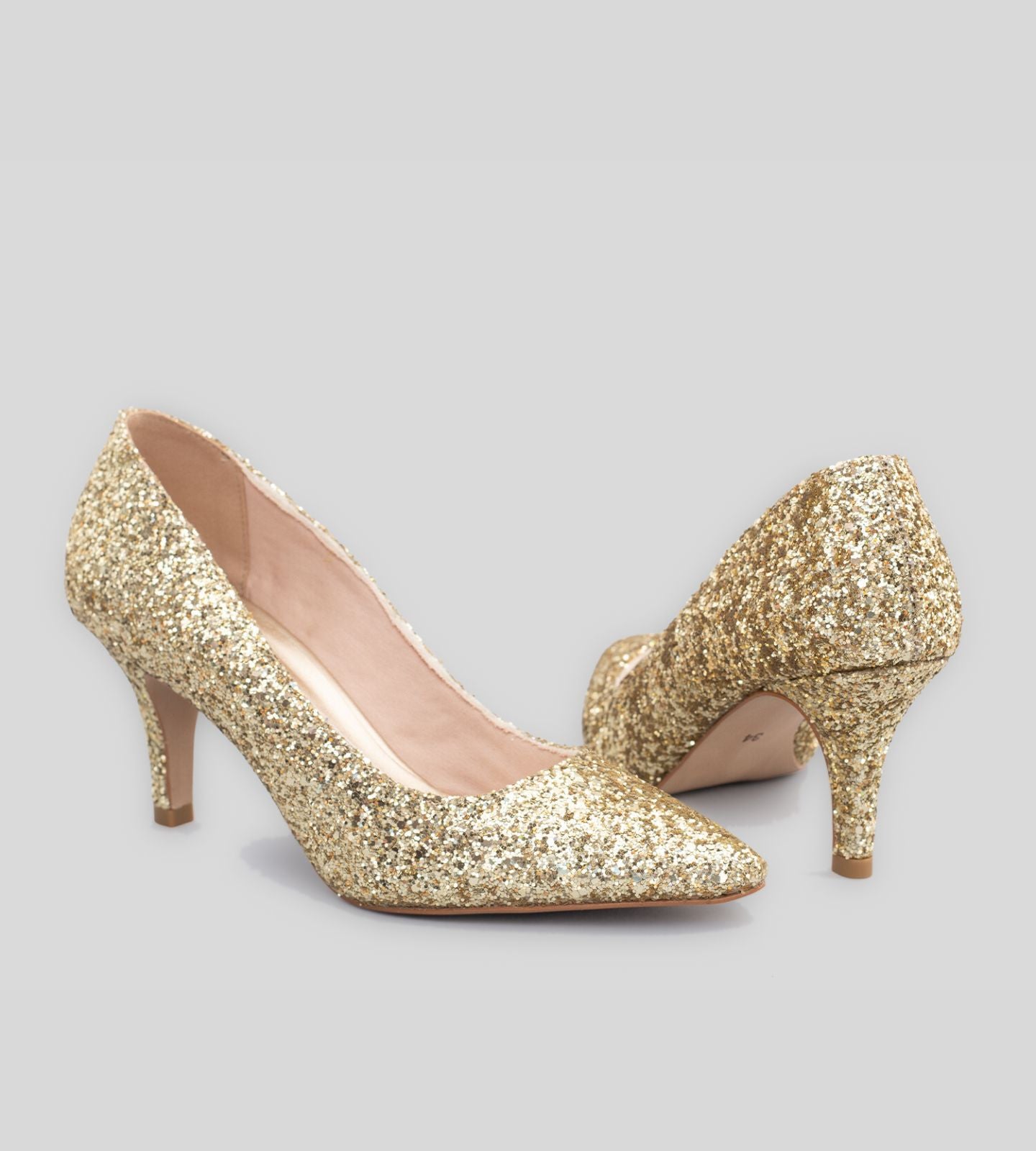 Scarpin em glitter dourado com salto de 7 cm, apresentando um design elegante e moderno. Com um acabamento brilhante, esse modelo é perfeito para ocasiões festivas e eventos especiais. A altura do salto proporciona um toque de sofisticação, enquanto o interior acolchoado garante conforto ao longo do dia. Ideal para complementar looks glamourosos e cheios de estilo.