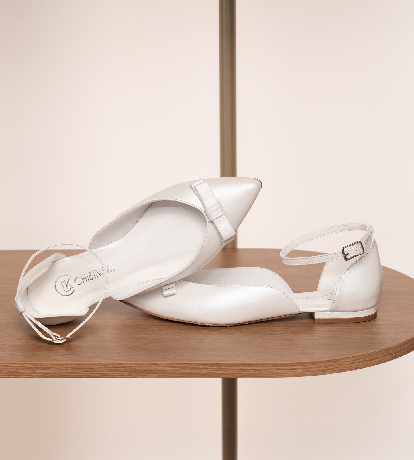 Sapatilha de noiva em couro perolado branco com laço delicado na parte frontal, design elegante e confortável.