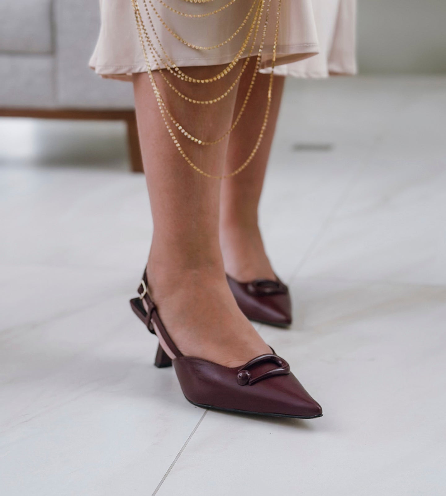 Scarpin slingback marsala em couro de alta qualidade, com detalhe frontal e fivela no calcanhar. O salto fino verniz de 8cm proporciona elegância e conforto, ideal para eventos especiais como casamentos e festas de debutantes. Um modelo sofisticado e moderno, perfeito para quem busca estilo e praticidade.