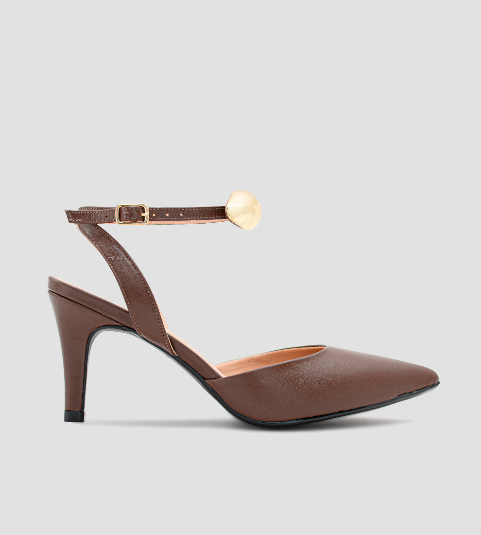 Sandália scarpin marrom em couro com salto fino de 9cm, bico fino e tornozeleira ajustável com detalhe metálico dourado removível.